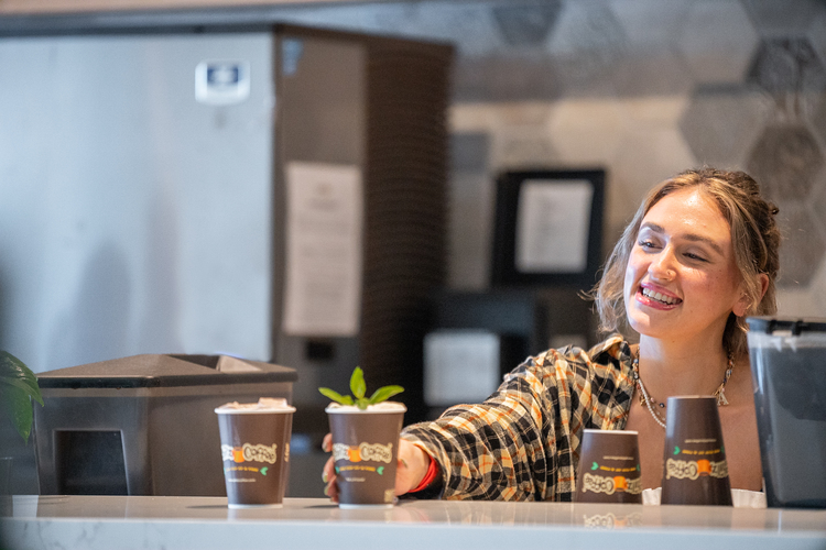 Barista woman serving coffee in Philz Coffee